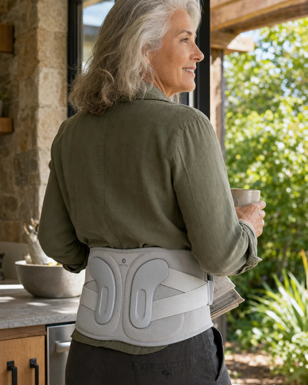 Active older adult wearing ESCOSY Lumbar One with its structured back supports visible