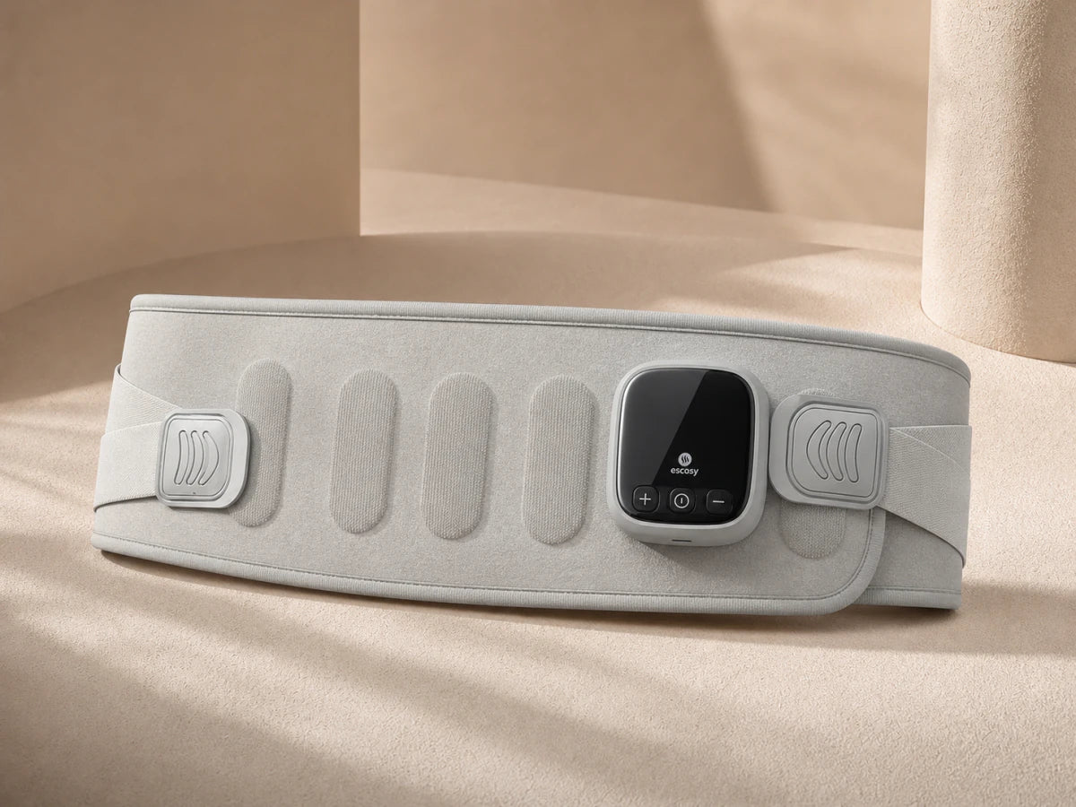 ESCOSY Lumbar One with its LCD control panel fixed to the front of the wrap on a warm studio surface